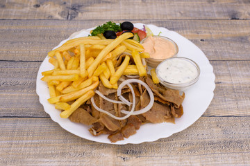 Kebab sandwich on white plate, with chips end rice