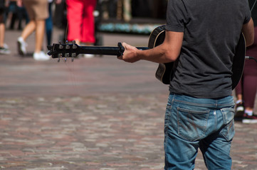 Closeup of guitarist playing on cobbles place in Mulhouse