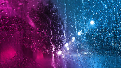 Rain through the glass with neon light