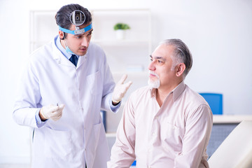 Male patient visiting doctor otolaryngologist