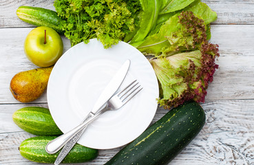 set of green vegetables on a wooden background for a healthy diet