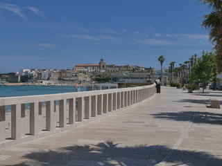 Fototapeta na wymiar Otranto southern promenade on the sandy beach. Otranto sandy beach and its white southern promenade are located on the Adriatic coast of Salento, Italy.