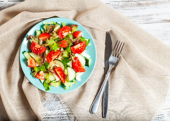 vegetable salad on a light, wooden background, the concept of a healthy diet, vegetarianism