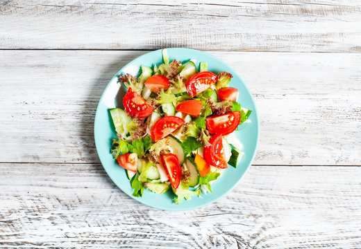 vegetable salad on a light, wooden background, the concept of a healthy diet, vegetarianism