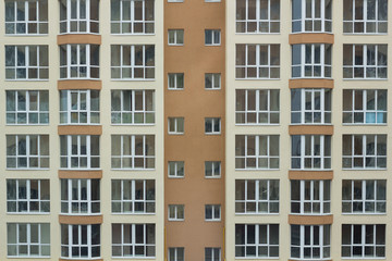 Frontal view of the facade of building with a lot of windows.