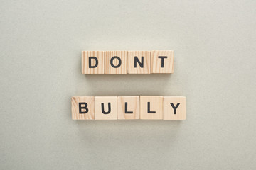 top view of wooden blocks with dont bully lettering on grey background