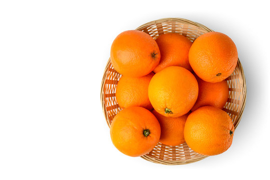 Fresh juicy oranges in wooden basket on white background Top view