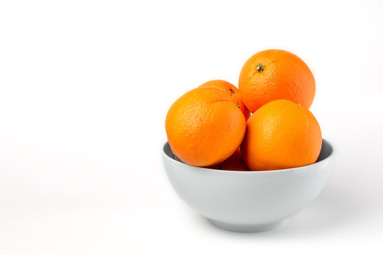Fresh juicy oranges on white plate on white background