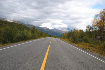 Road along beautiful nature towards a mountain