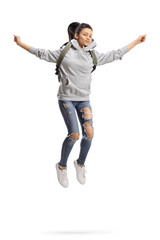 Female student with backpack jumping