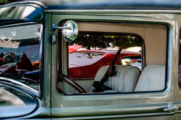 Interior view of an antique car with 'Tommy Gun' in the front seat
