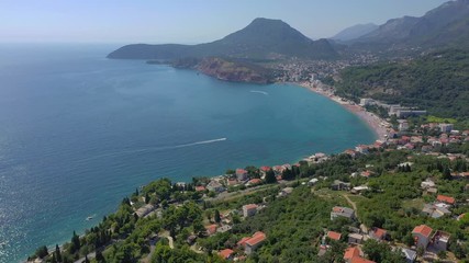 Flying over the seacoast to the turquoise sea