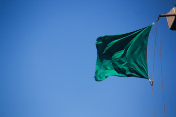 Green flag with blue sky background