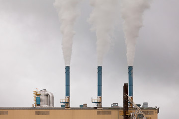 Industry chimneys polluting warming atmosphere