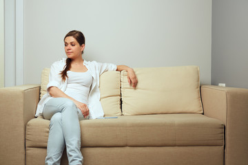 Obraz premium Smiling woman relax at home on couch.
