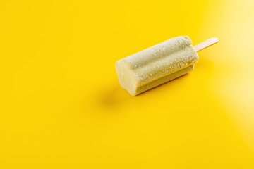 fresh yellow popsicle on a yellow background