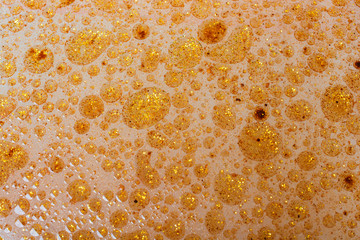 Macro shot of oil bubbles over colored background