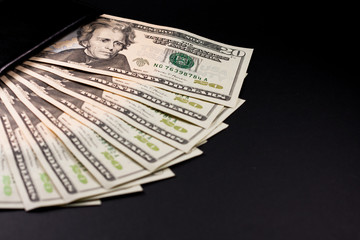 Twenty dollar bill. 20 dollar bill. Image isolated on black background. Fan-shaped tickets introduced in a wallet.