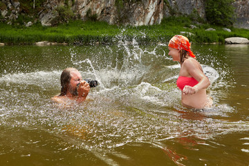 Water play by man and young woman.