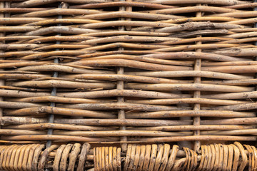 Horizontally intertwined brown willow rods with small vertically intertwined rods at the bottom.