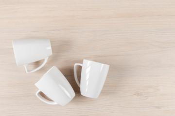 White ceramic cups on wooden background, image