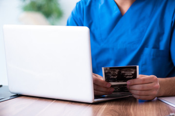 Young male doctor looking at doppler images