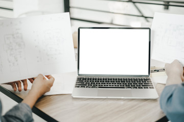 Mockup image of engineers using laptop to drawing design building Project in office, mockup concept