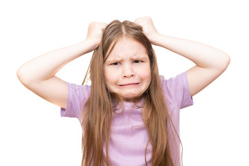 A little girl pulls her hair. Isolated on a white background.