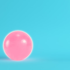 Pink crystal ball with paddles on bright blue background in pastel colors