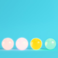 Four colorful crystal balls on bright blue background in pastel colors.