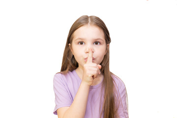 The little girl put her index finger to her mouth. Isolated on a white background.