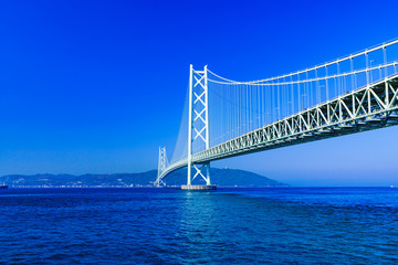 Landscape of Akashi Kaikyo Bridge in the background of blue sky in the summer morning
