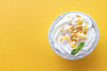 Summer fruit dessert is Mango cheesecake on yellow table background