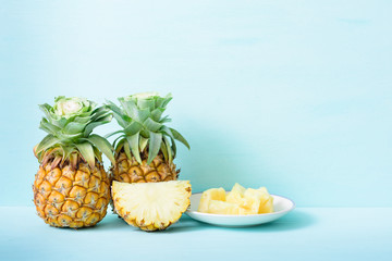 Fresh sliced pineapple on green background, tropical fruit