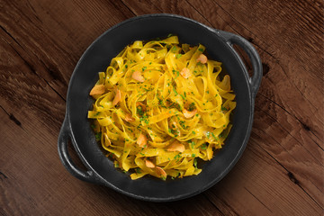 Traditional Italian pasta on black rustic pan