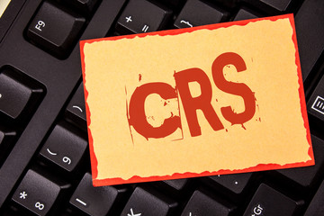 Word writing text Crs. Business concept for Common reporting standard for sharing tax financial information written Sticky Note Paper placed Black Keyboard. Top view.