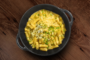 Traditional Italian pasta on black rustic pan