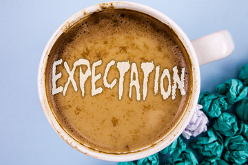 Conceptual hand writing showing Expectation. Business photo showcasing Meteorological research analyst predicts weather forecast written Coffee in Cup plain background Paper Balls.