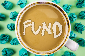 Word writing text Fund. Business concept for Large amount of money is released from bank for particular purpose written Tea in White Cup within Crumpled Paper Balls plain background.