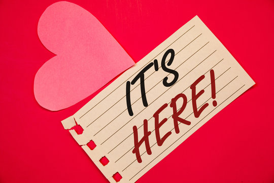 Text sign showing It Is Here Motivational Call. Conceptual photo Present in this moment Thing or place foundNotebook page red background Pink Heart Black letters Love note romantic - Powered by Adobe