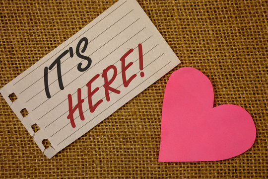 Text sign showing It Is Here Motivational Call. Conceptual photo Present in this moment Thing or place foundNotebook page Wicker background Pink Heart Black Red letters Love note - Powered by Adobe