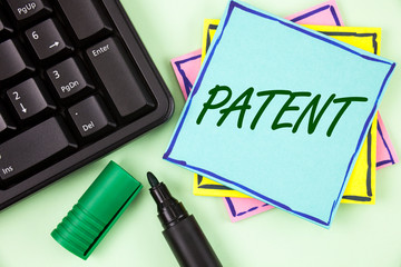 Handwriting text writing Patent. Concept meaning License that gives rights for using selling making a product written Sticky Note paper plain Green background Marker and Keyboard.