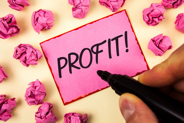 Text sign showing Profit Motivational Call. Conceptual photo Earned Money Payment Salary Business Revenue written by Man Sticky Note paper holding Marker plain background Paper Balls.