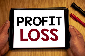 Text sign showing Profit Loss. Conceptual photo Financial year end account contains total revenues and expensesMan hold holding table with ideas words white screen black red pens wooden