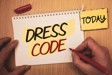 Text sign showing Dress Code. Conceptual photo Rules of what you can wear and not to school or an eventMan creating for today on notebook Hand hold holding pen Wooden background