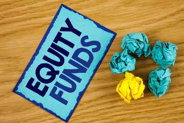Word writing text Equity Funds. Business concept for Investors enjoys great benefits with long term investment written Sticky Note paper wooden background Paper Balls next to it.