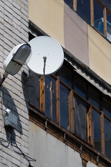 Satellite TV on the wall of a multistory building.