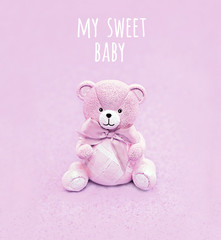 my sweet baby. cute teddy bear on abstract blurred pink background. greeting card background. Concept of birthday, newborn holiday, Valentine's Day. close up. soft selective focus