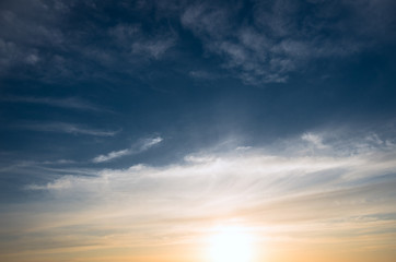 Naklejka na ściany i meble Sunset and cirrus clouds on a bright blue sky.