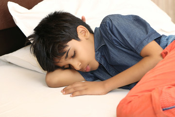 Indian boy sleeping in bed at home